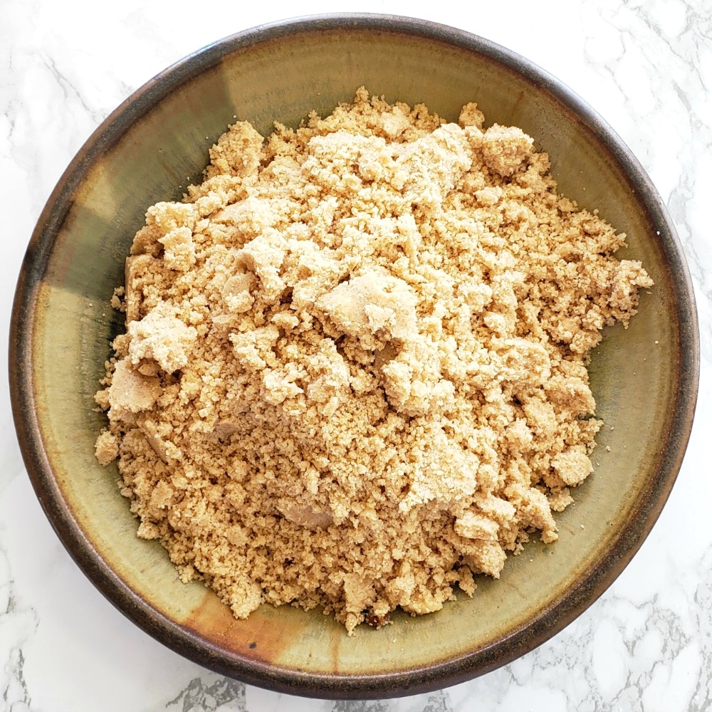 Brown pottery bowl of Streusel for Jam Breakfast Cake with Streusel 