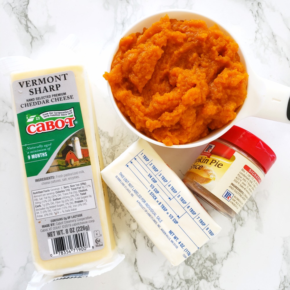 Ingredients for Pumpkin Cheddar Biscuits on a white marble counter on ShockinglyDelicious.com