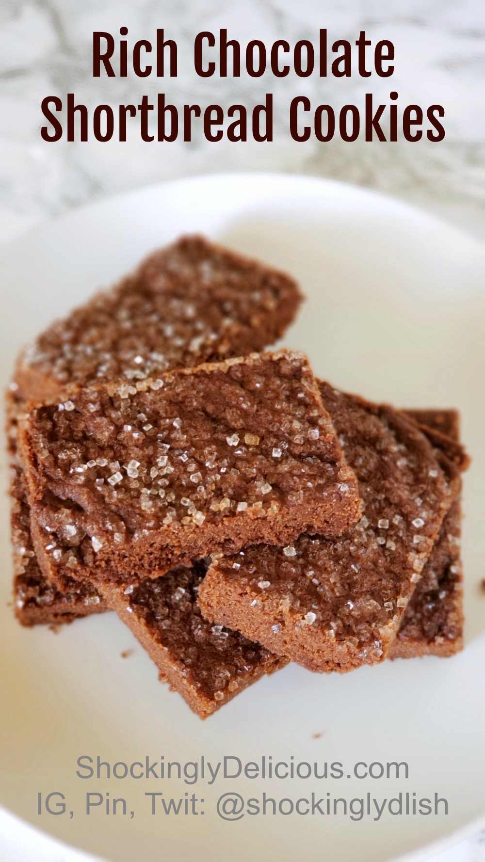 A stack of Rich Chocolate Shortbread Cookies on a white plate on ShockinglyDelicious.com