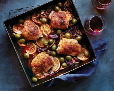 Roast Chicken Thighs with Meyer Lemon and Smoked Paprika: Meaty chicken thighs boast a deep orange color, roasting atop a succulent bed of red onion and sliced Meyer lemon.