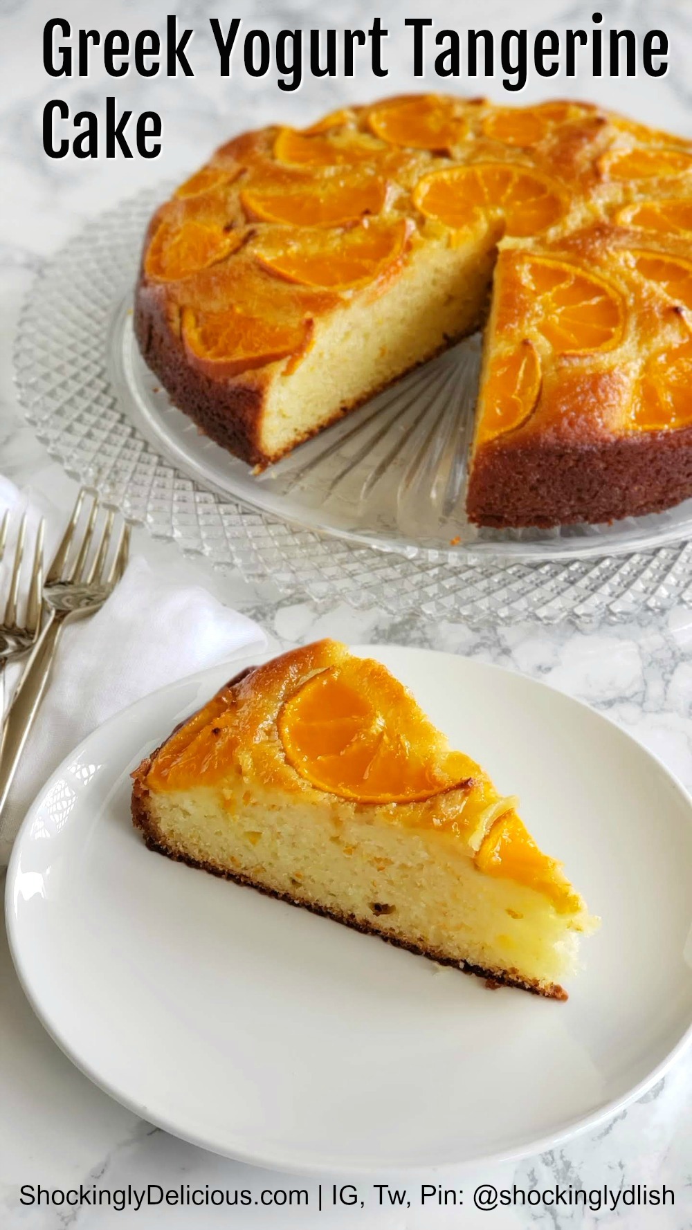 Cake on a plate, with large cake behind it on a white marble counter