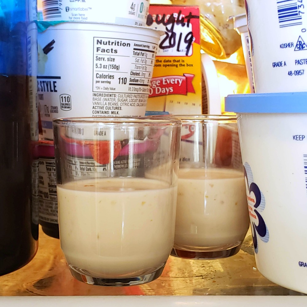 Orange Posset in glass cups resting the refrigerator