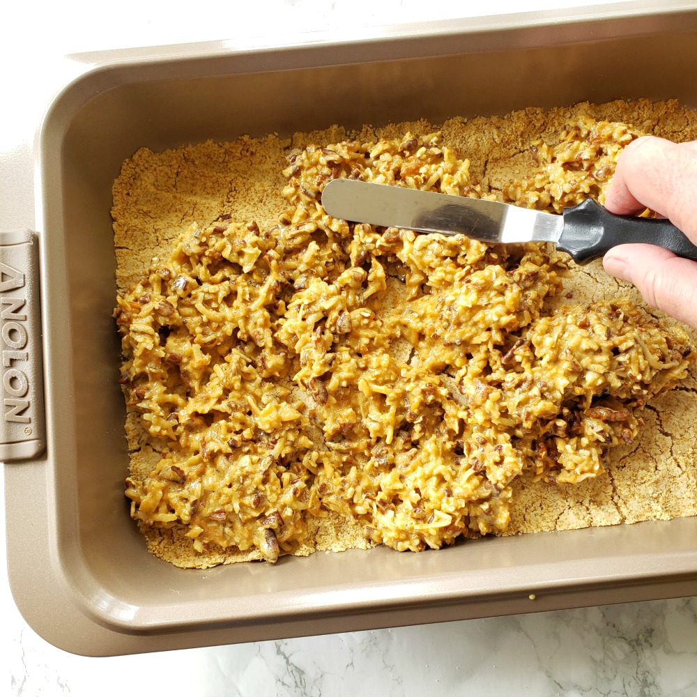 Filling is spread over crust using a small spatula