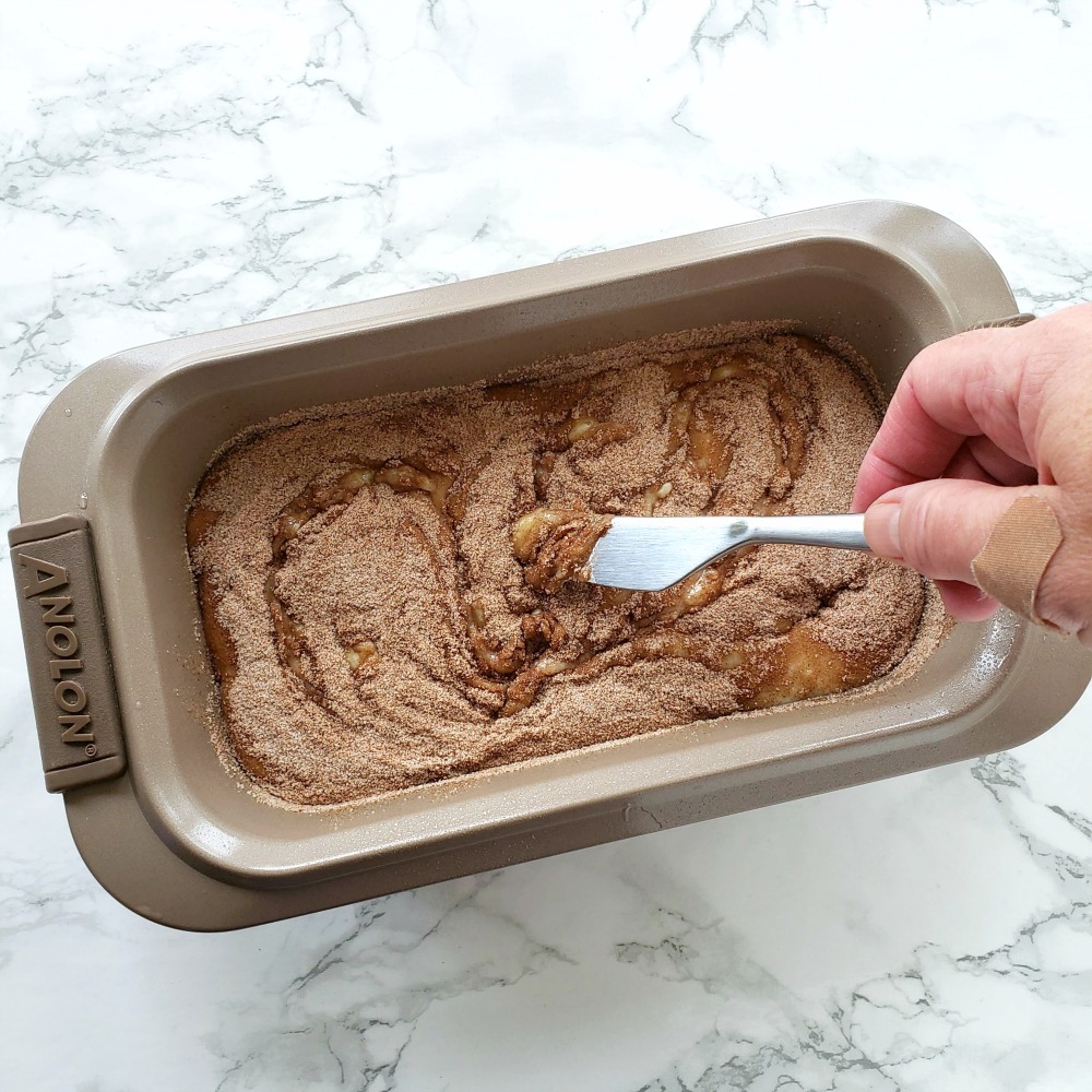 Cinnamon sugar is being swirled into bread batter