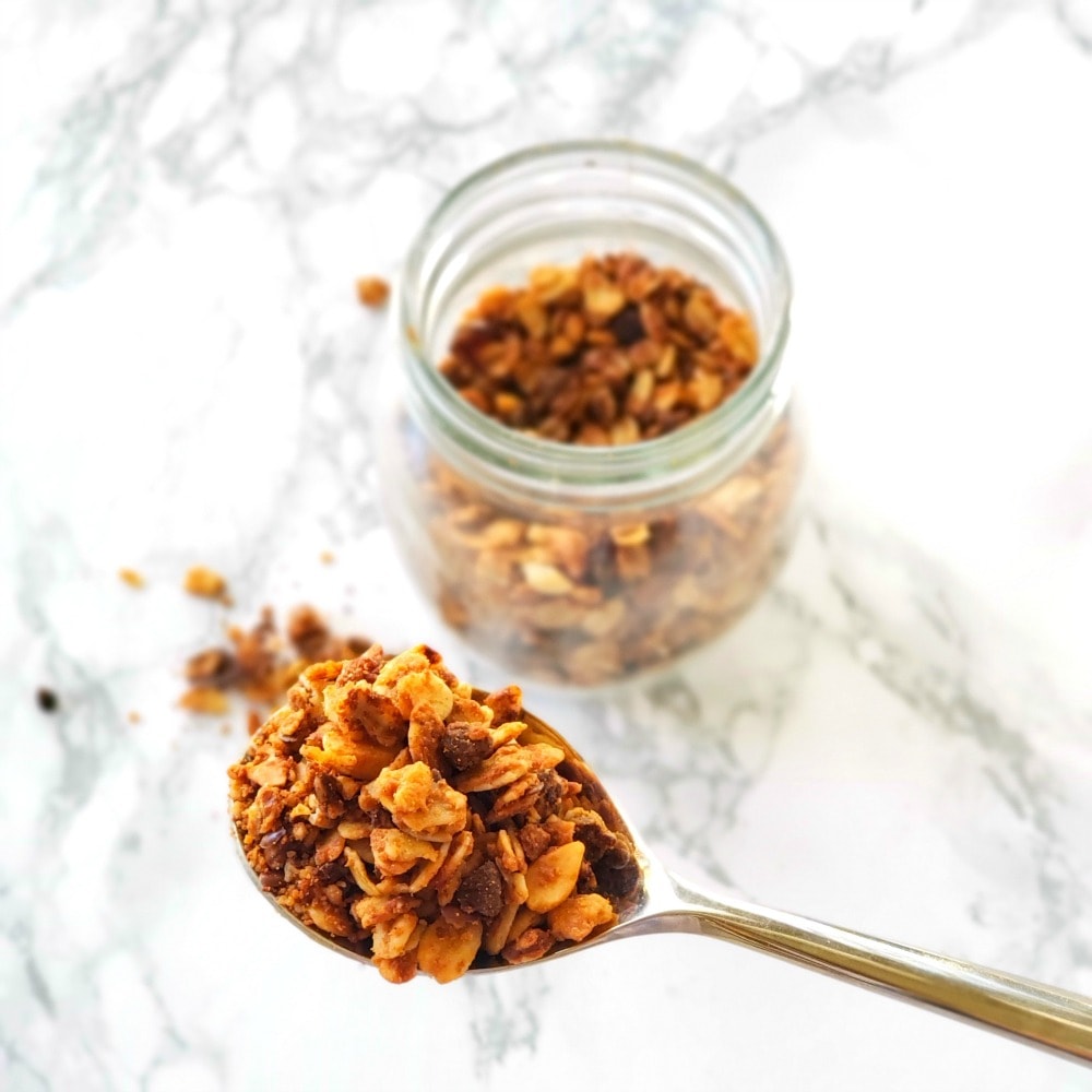 Honey Nut Granola is simple, with a peanut butter and honey base coating oats, flax, dried fruit, almonds and chocolate. It's perfect for breakfast or snack.