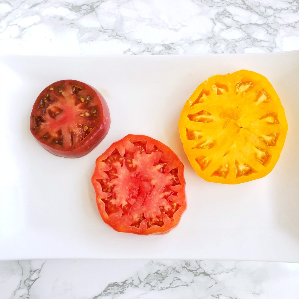 Tomato slices on a white platter