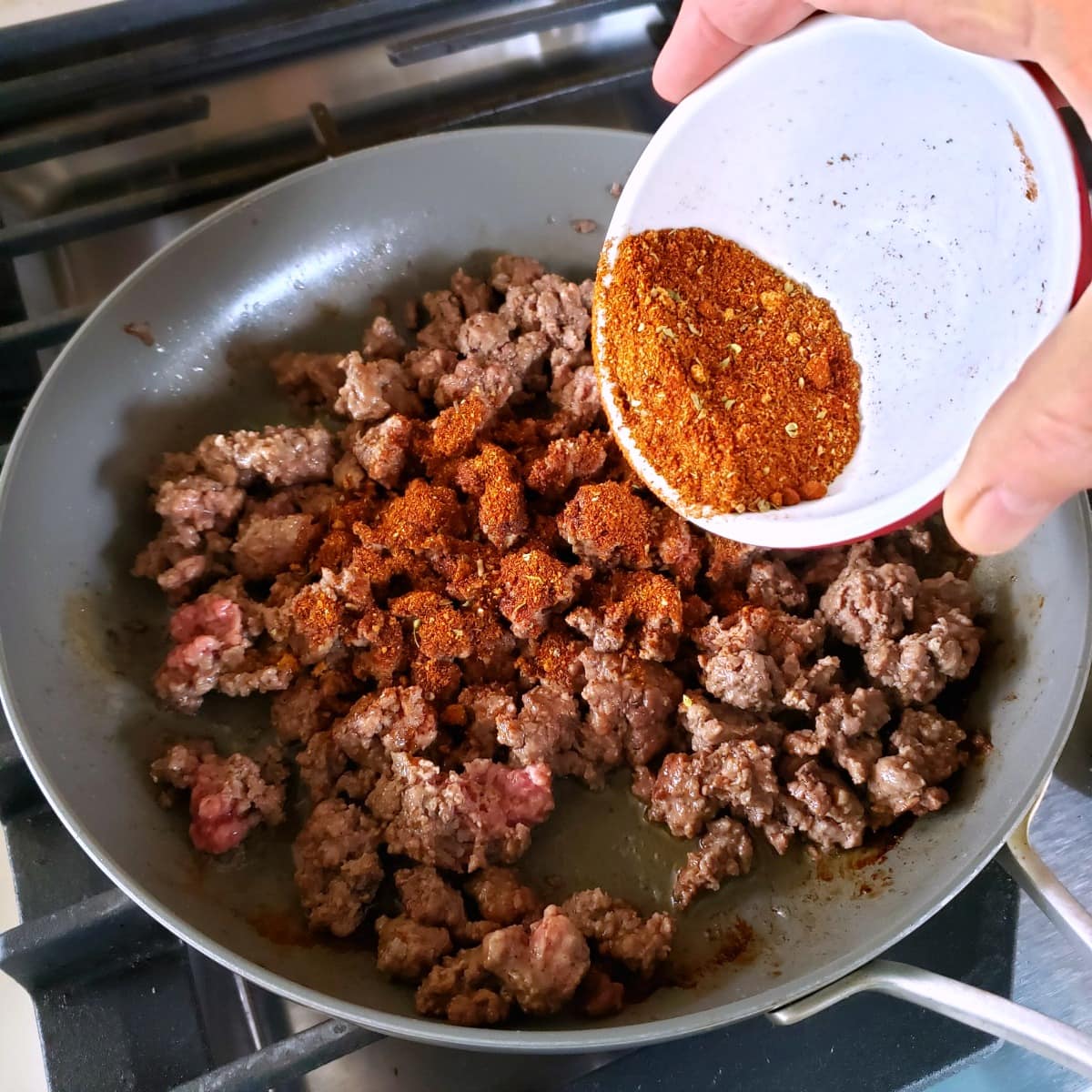 Add chili spices to the ground beef