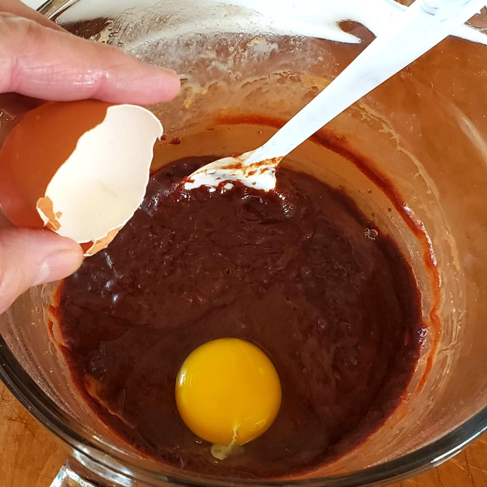 Cracking an egg into the batter