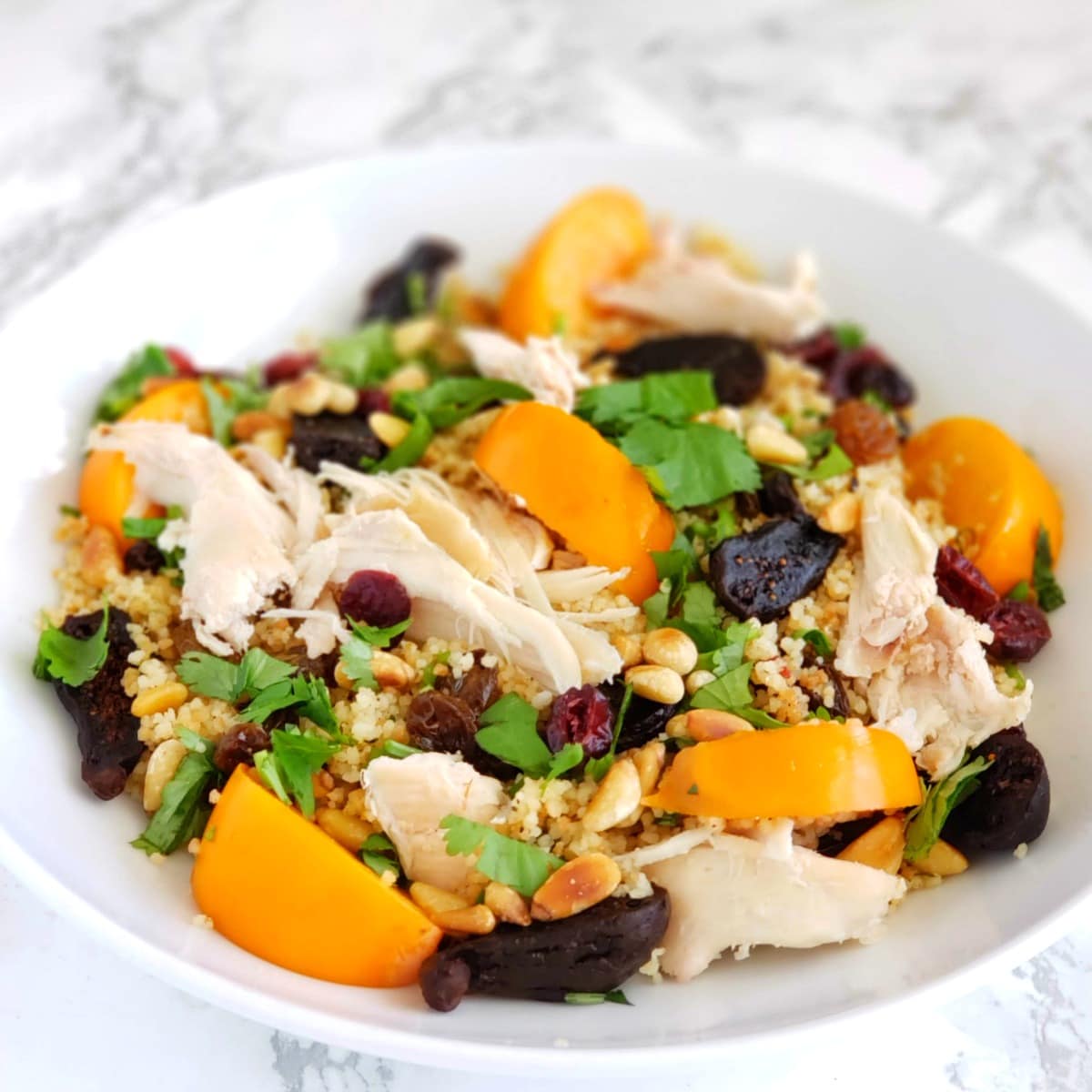 Chicken and fruit on top of couscous