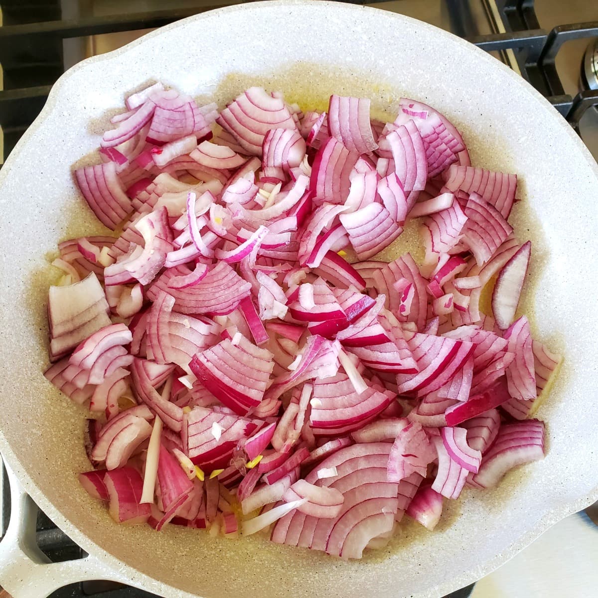 Red onions sautéed in a skillet