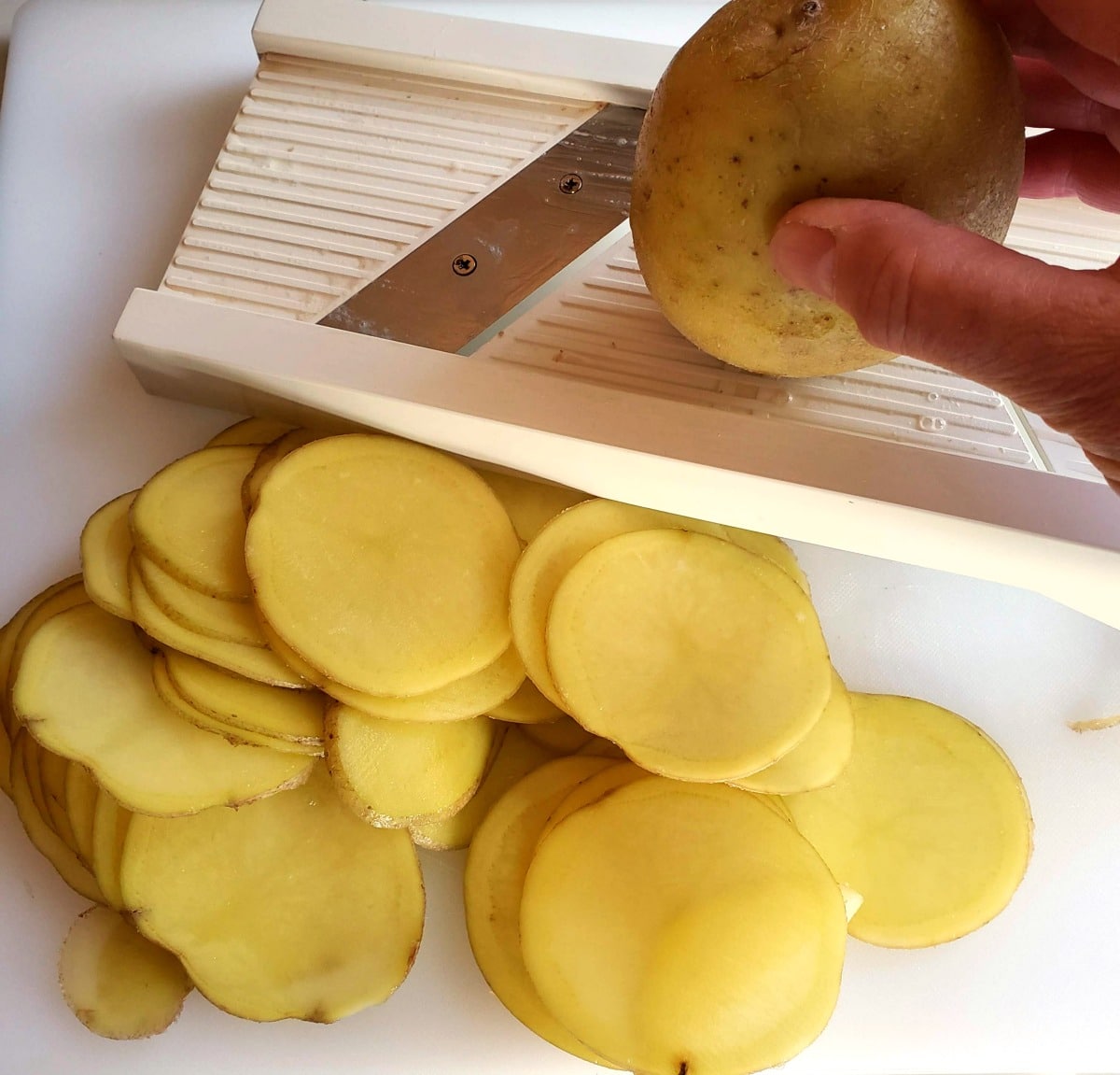 Slice the potatoes with a mandolin