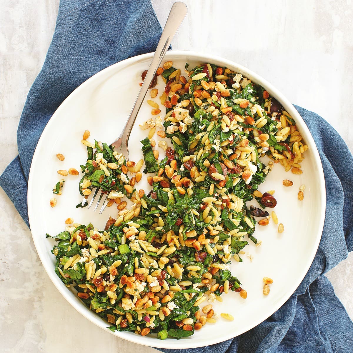 Spinach Orzo Salad is a fast, easy, delicious spinachy side salad chock full of salty feta and olives, flavorful sun-dried tomatoes and toasted pine nuts. Add cooked chopped chicken or another protein to make this a main meal.