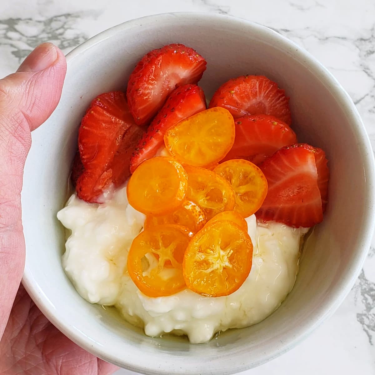 Breakfast bowl with cottage cheese, strawberries and No-Cook Candied Kumquats on ShockinglyDelicious.com