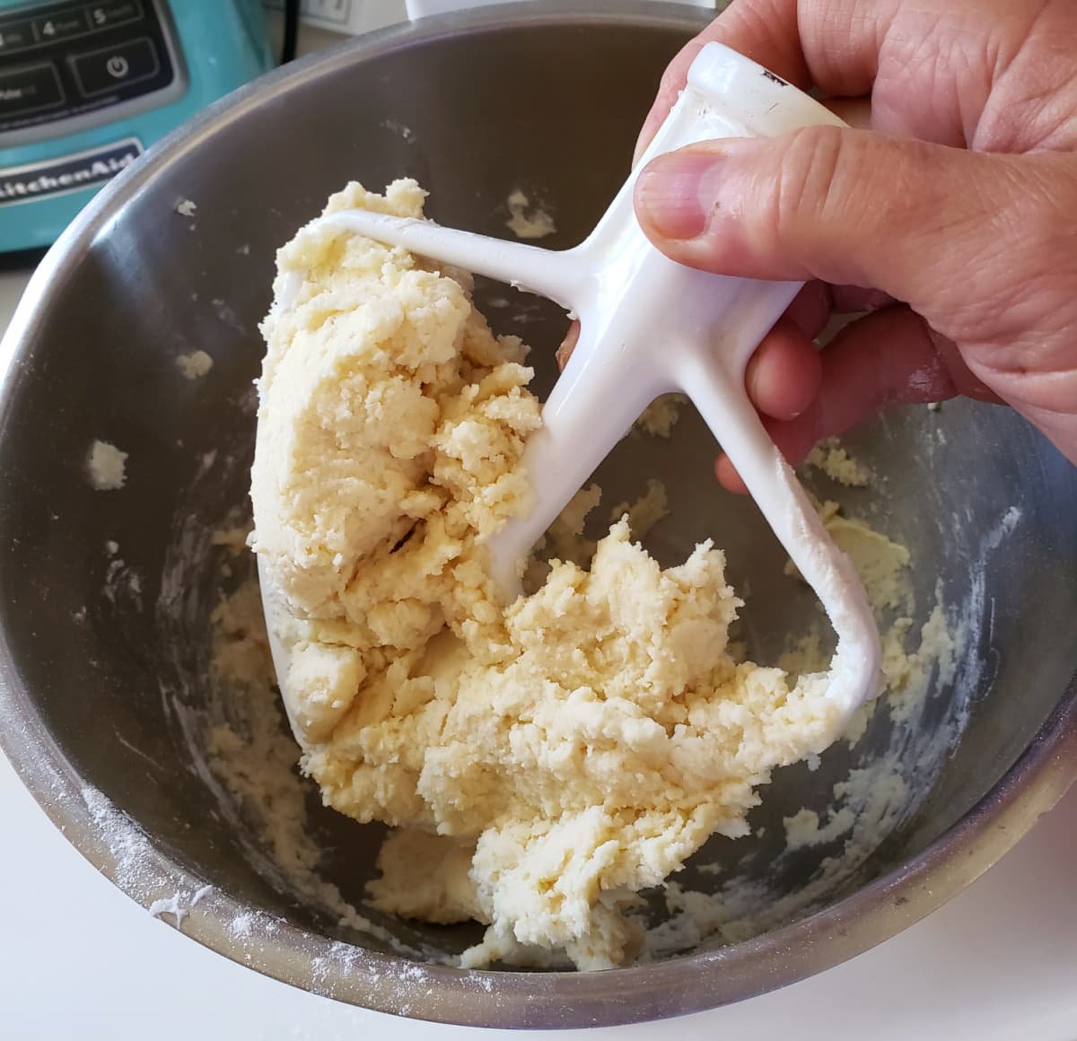Lemon Shortbread dough is thick on the mixer paddle