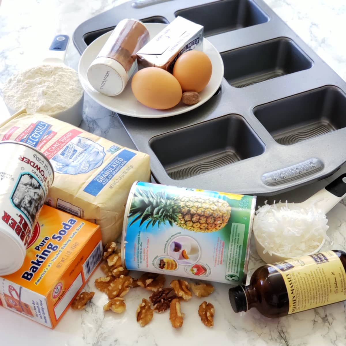 Ingredients for Pineapple Coconut Quick Bread on a white marble counter