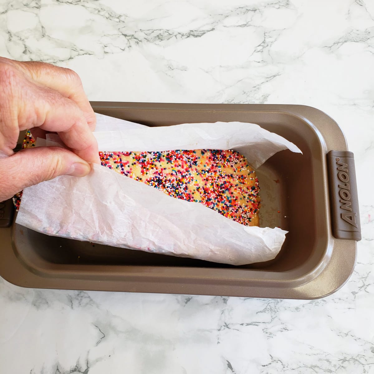 Parchment paper handles help to lift shortbread from pan