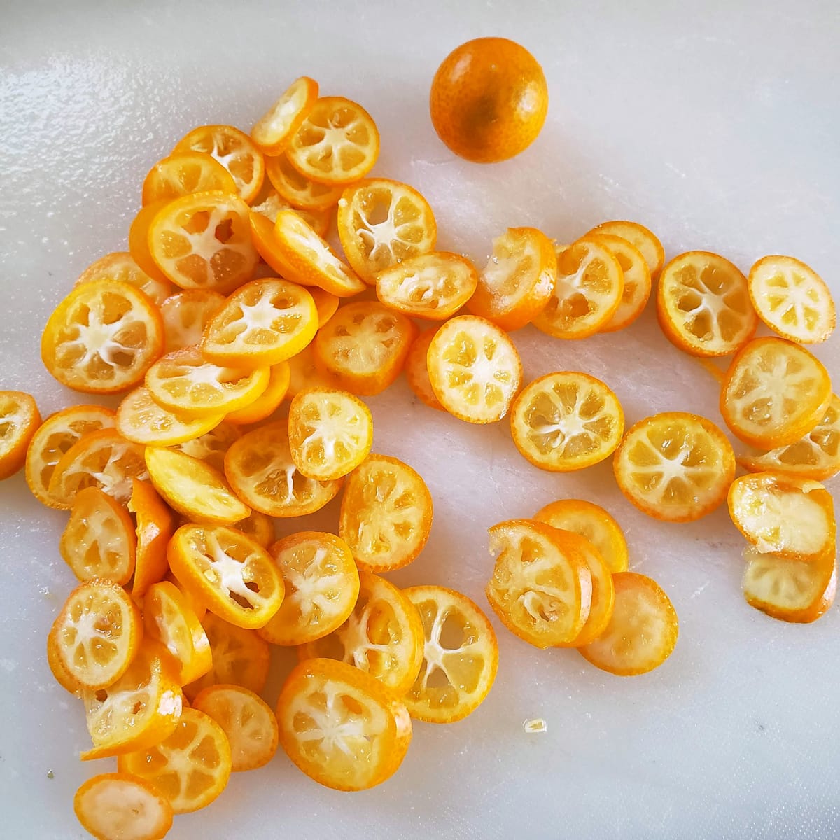 Sliced kumquats on a cutting board