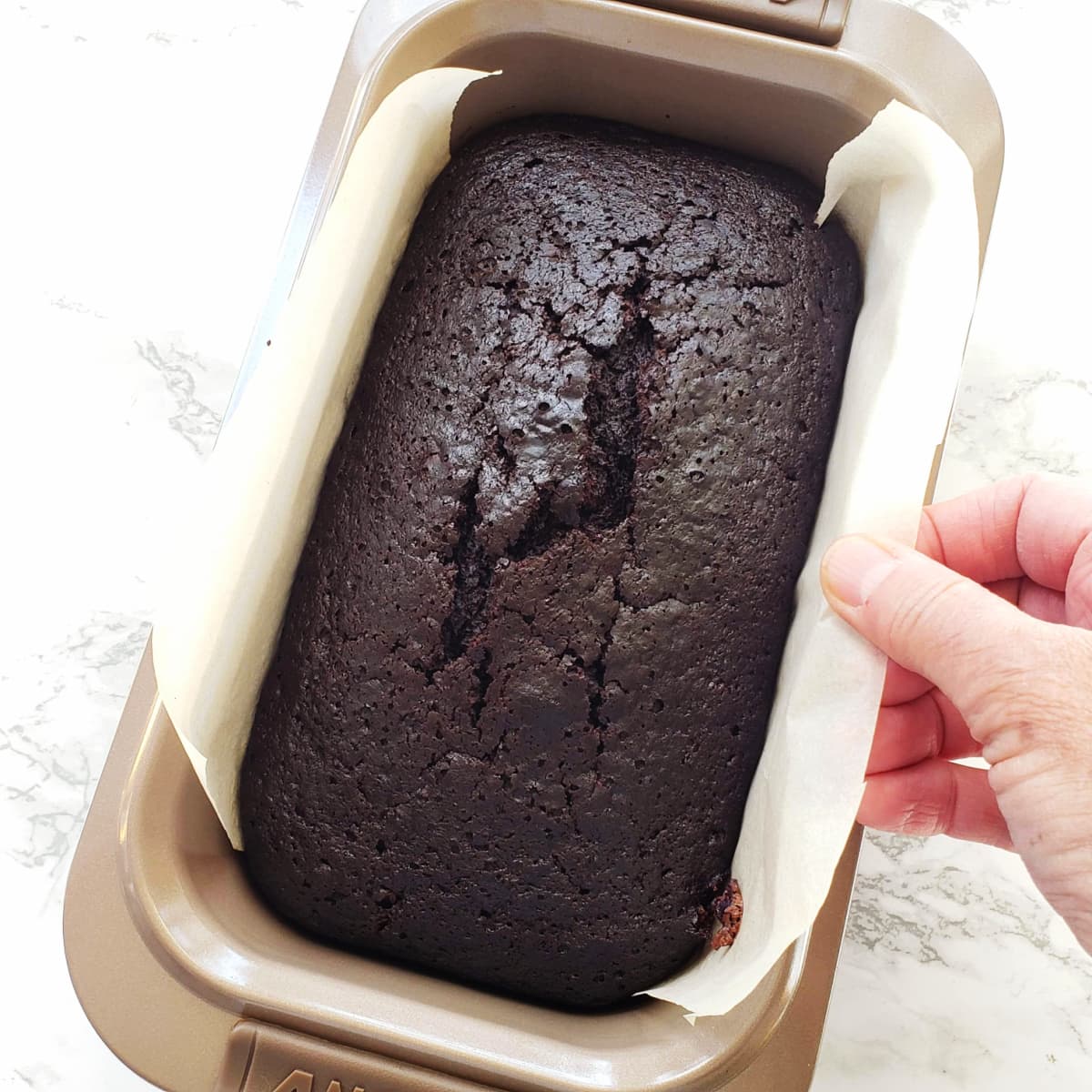 Line the loaf pan with parchment leaving overhang on 2 edges to use as handles