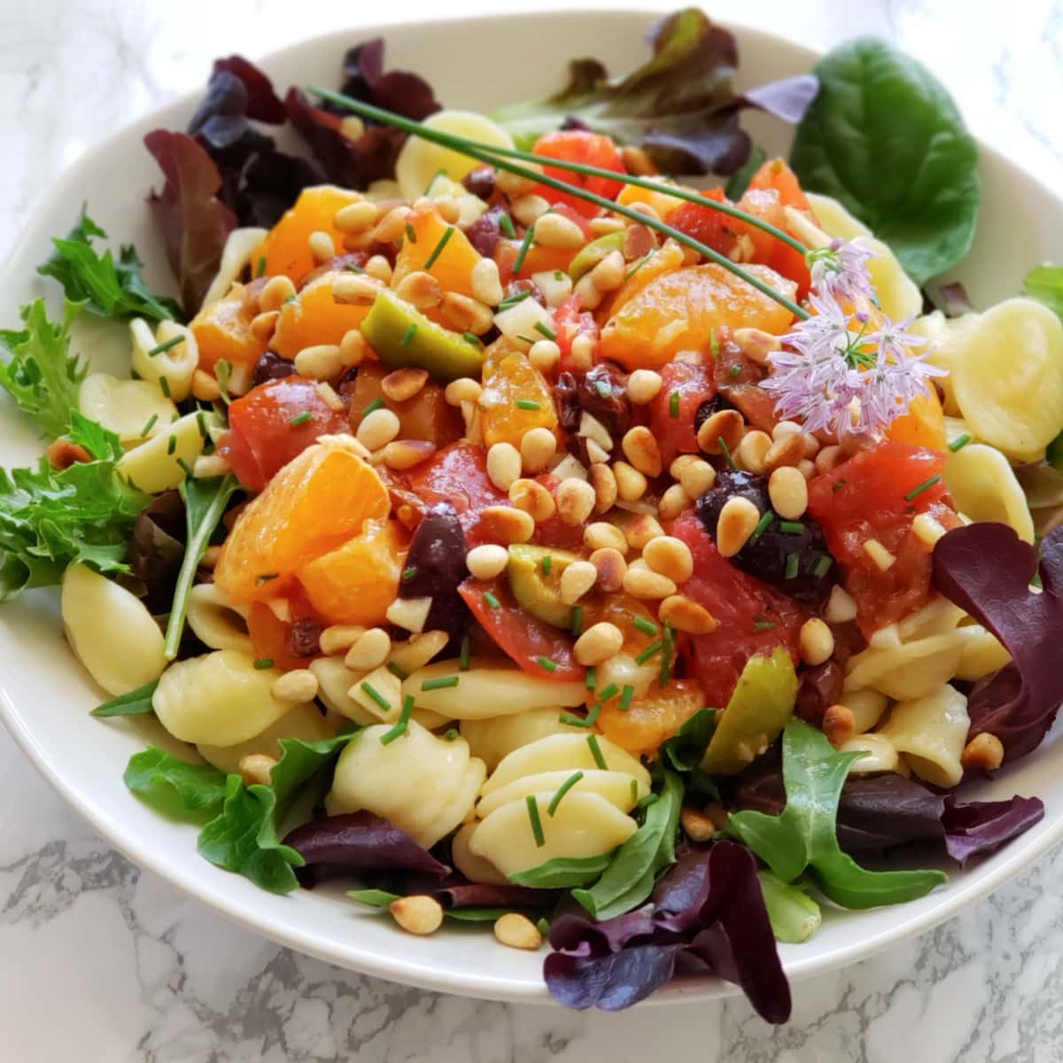 Pasta with Fresh Tomatoes and Tangerines, Fennel, Currants and Olives is a sweet and tart pasta dish with a no-cook, chunky, chopped sauce served at room temperature.