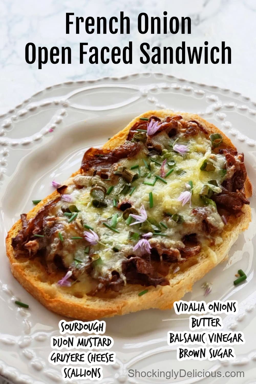 French Onion Open Faced Sandwich has all the flavor and umami of the traditional soup, but in sandwich form. This is the sandwich that will convince you that sandwiches can be dinner. #shockinglydelicious #sandwichrecipe #frenchonionsandwich #dinnersandwich French Onion Open Faced Sandwich on a white plate on a white marble counter on ShockinglyDelicious.com