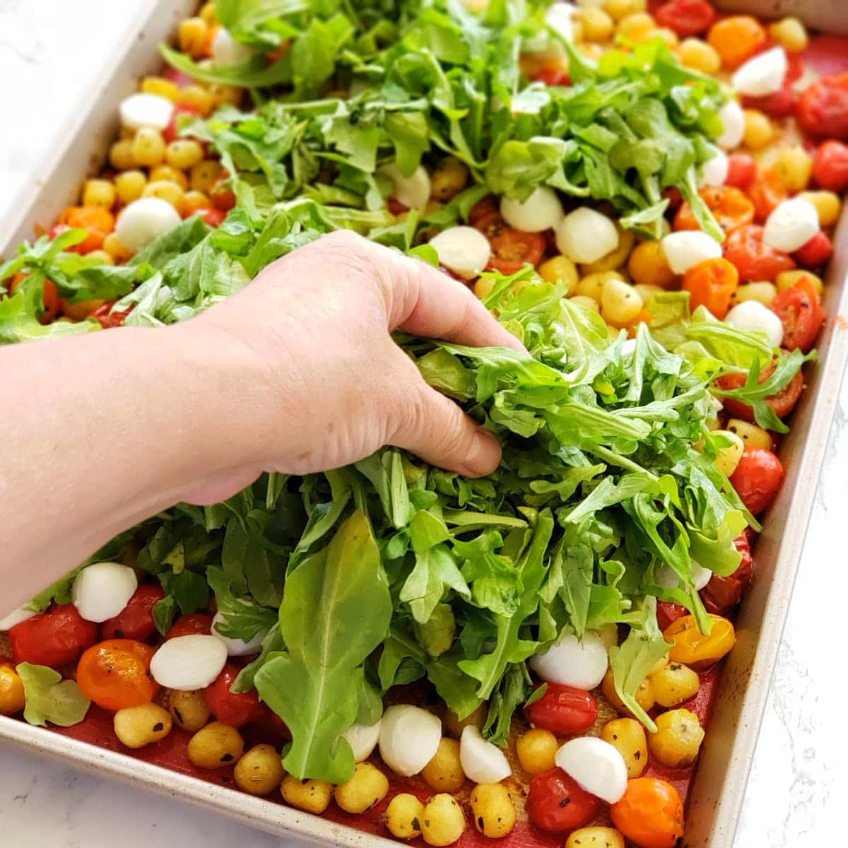 Add fresh arugula to the baking sheet