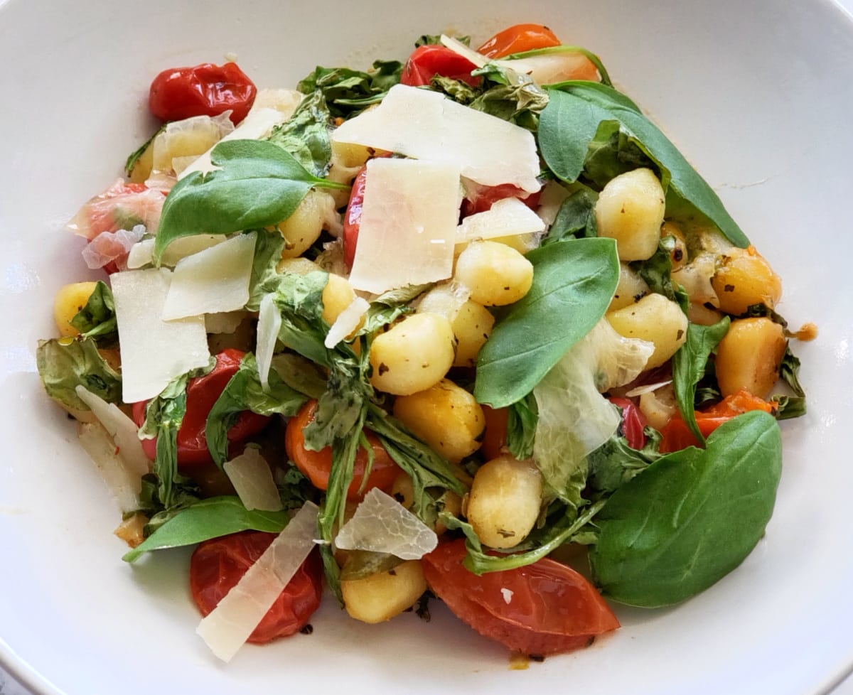 Sheet Pan Gnocchi with Cherry Tomatoes, Mozzarella and Arugula is the fresh taste of summer in a dinner bowl. A quick roasting makes it easy.