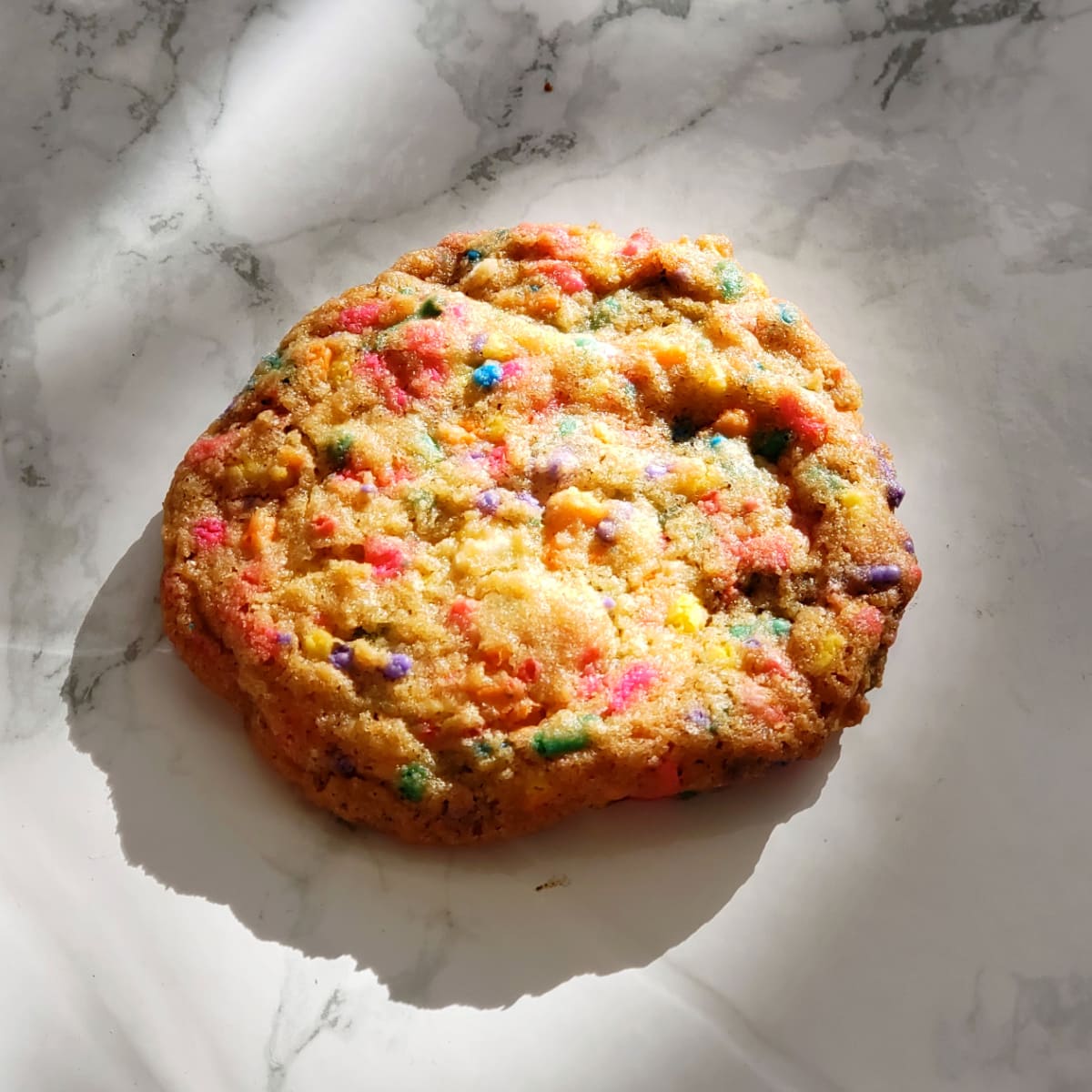 Colorful Confetti Sprinkle Cookie in sunlight on a white marble counter