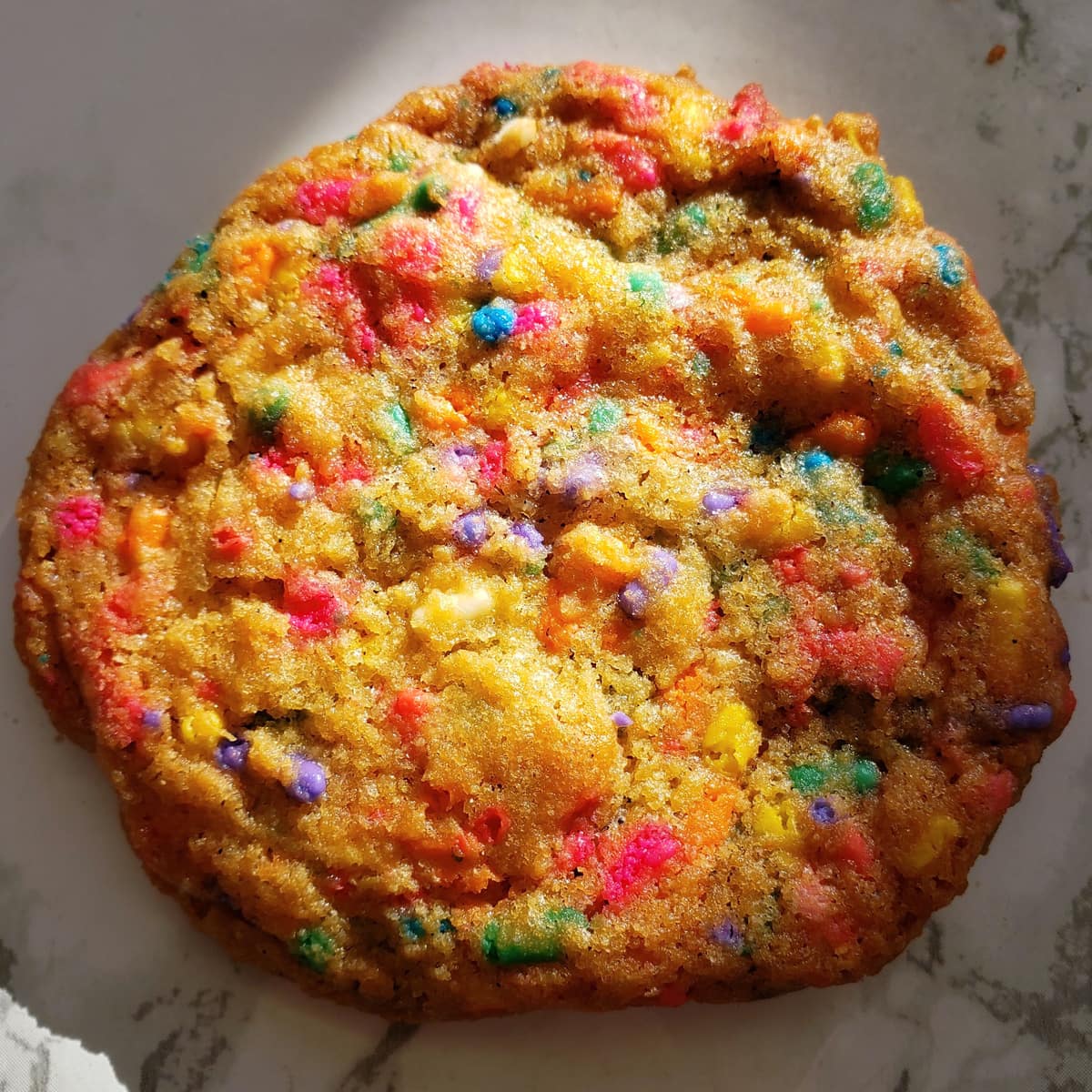 Confetti Sprinkle Cookie with moody lighting showing off the colorful sprinkles