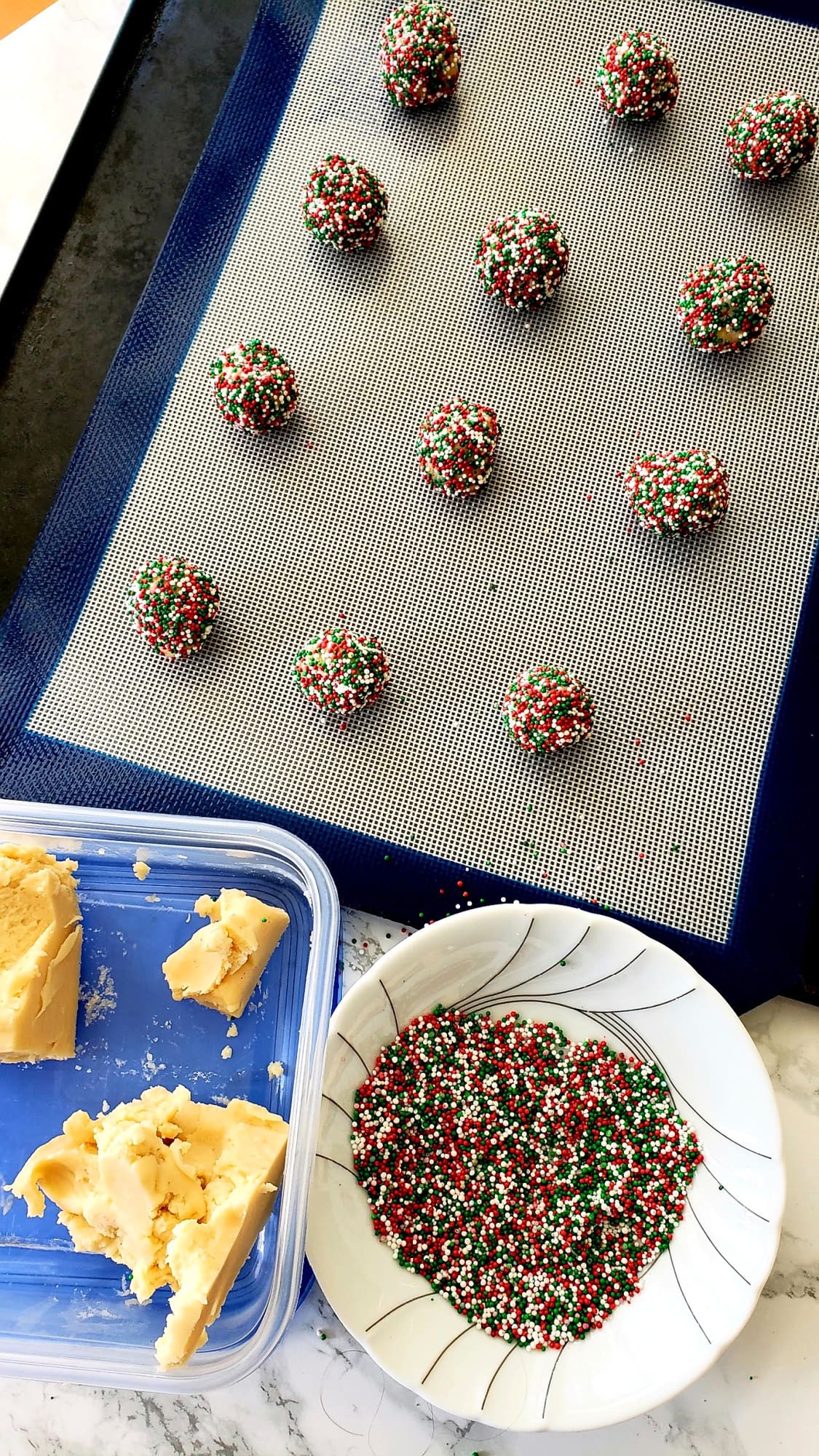 12 cookies on a silicone baking liner ready for the oven