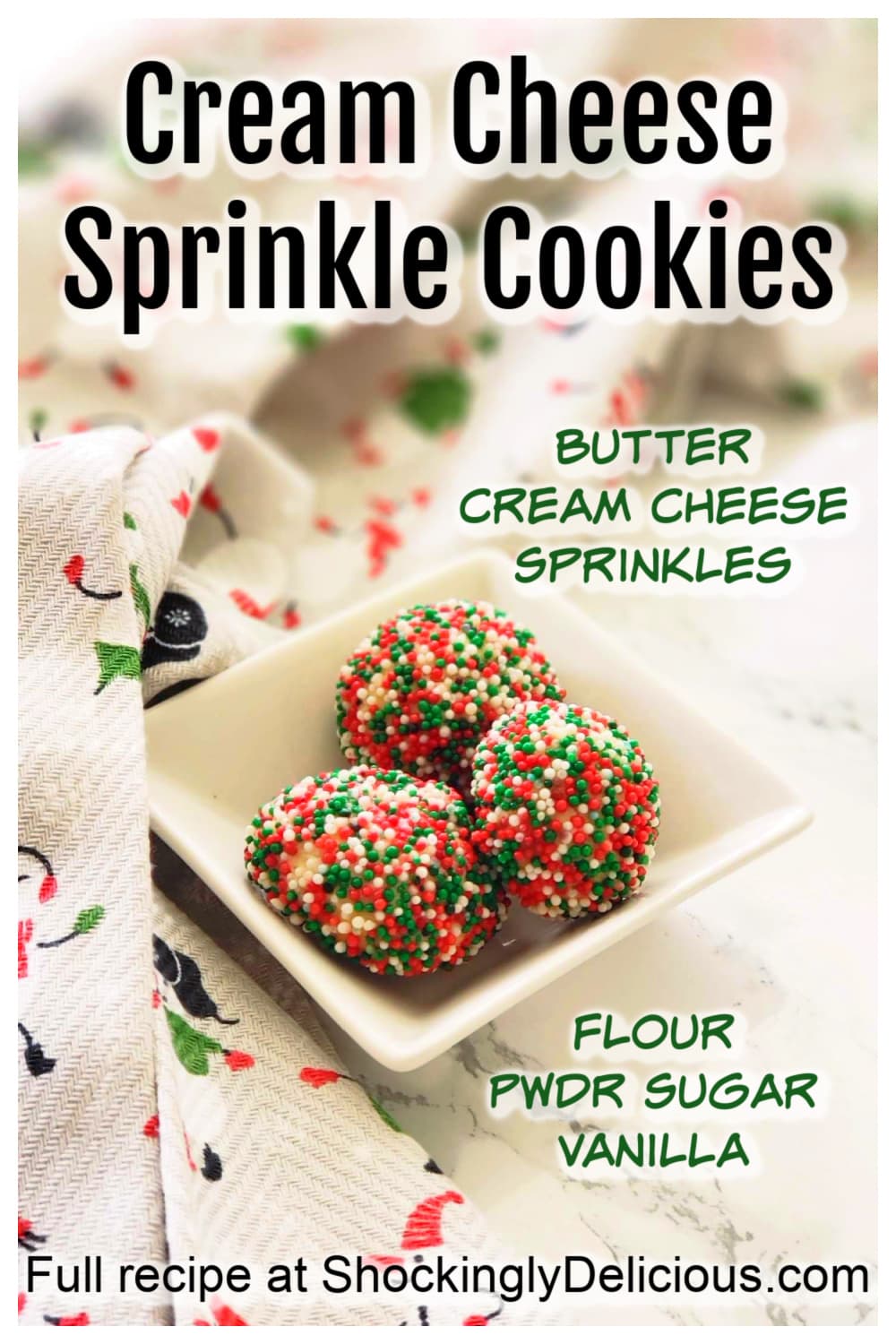 3 Cream Cheese Sprinkle Cookies in a small white square bowl with recipe title superimposed over a Christmas tea towel on ShockinglyDelicious.com