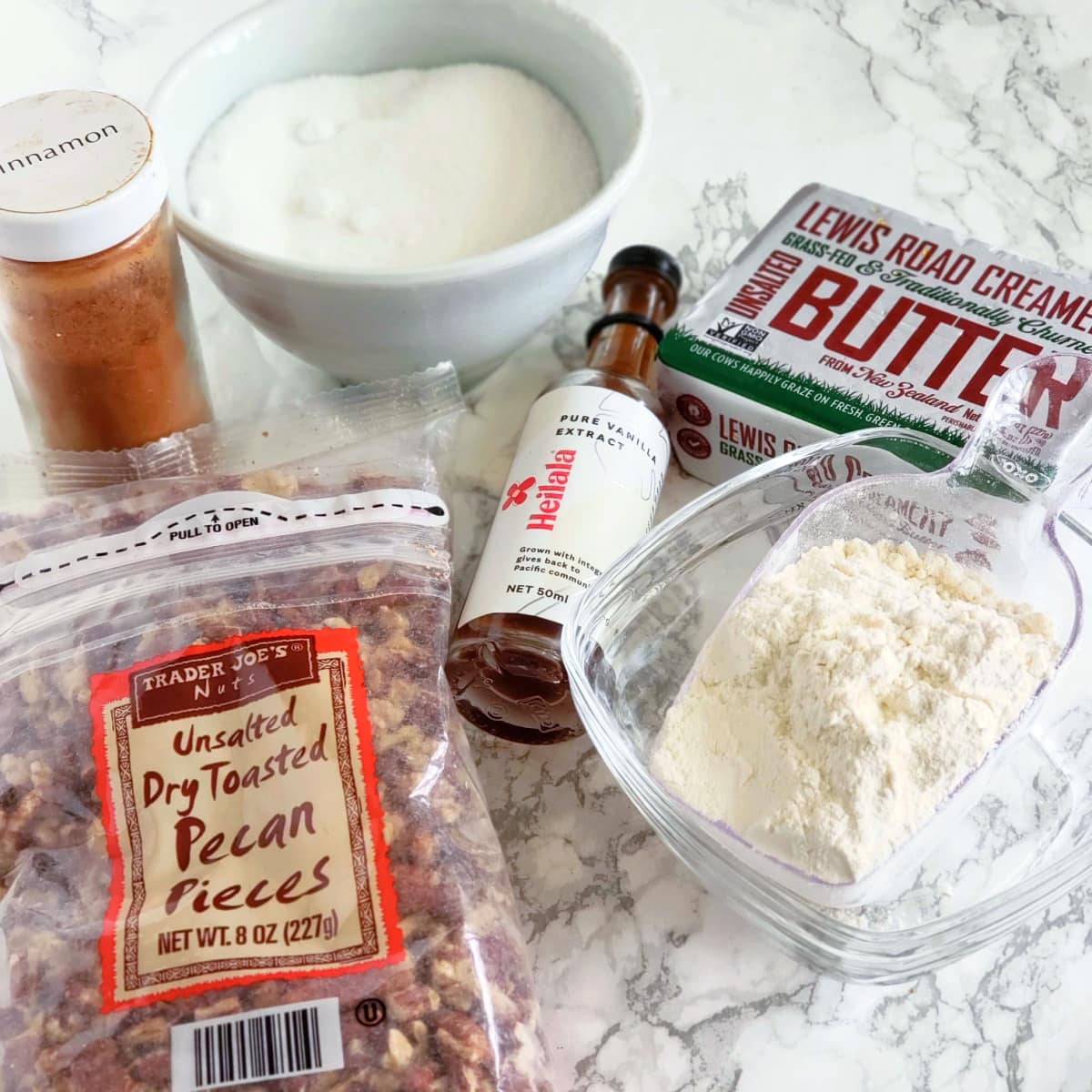 Ingredients for Mexican Wedding Cookies arrayed on a white marble countertop