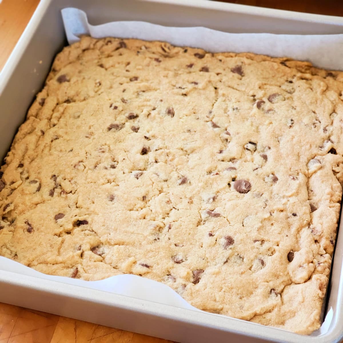 Light brown Chocolate Chip Pecan Shortbread Cookies in a gold toned baking pan