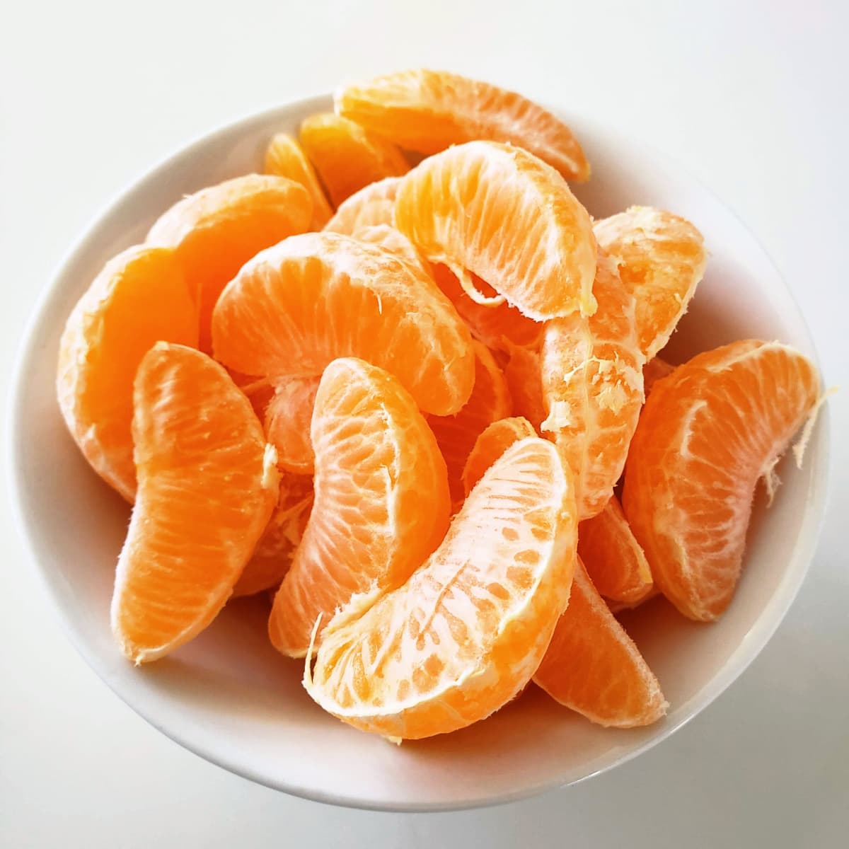Tangerine segments in a bowl on ShockinglyDelicious.com