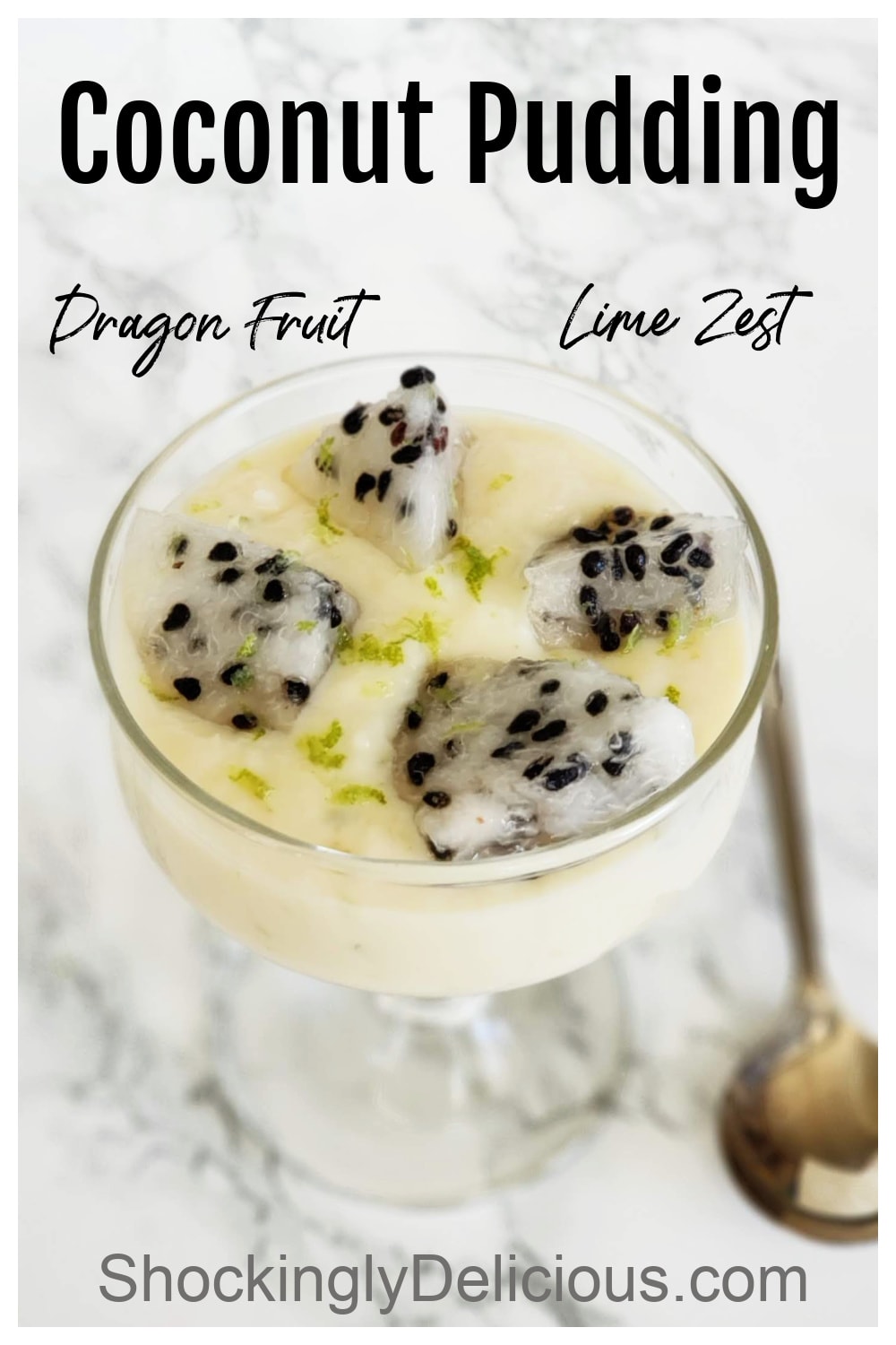 Coconut Pudding in a glass goblet with pieces of white dragon fruit on top, a spoon alongside, on a white marble counter