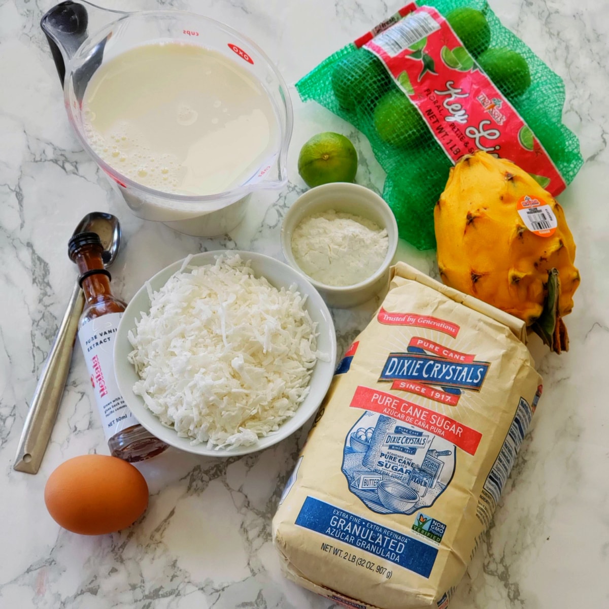 Ingredients for Coconut Pudding arrayed on a white marble countertop