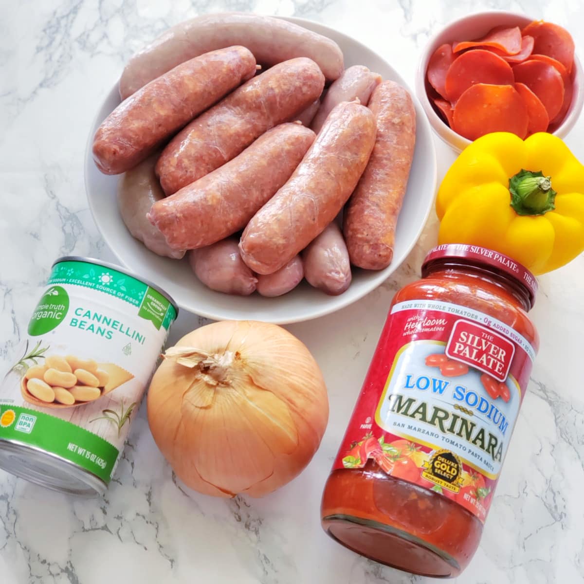 Ingredients for Pizza Chili laid out on a marble counter