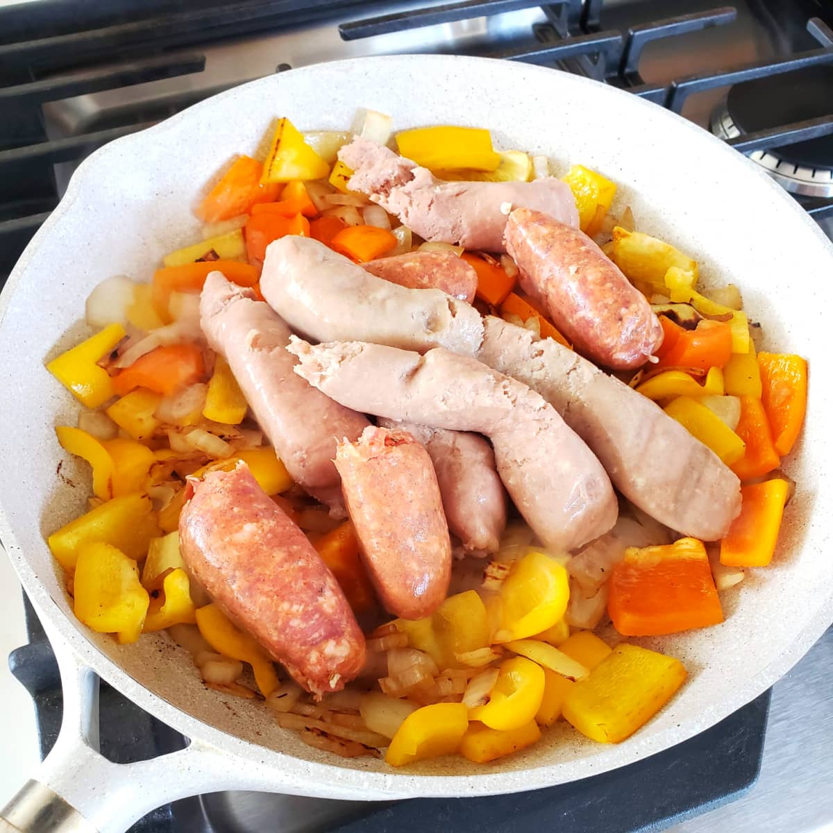 Italian sausage sauteeing in the skillet for Pizza Chili on ShockinglyDelicious.com