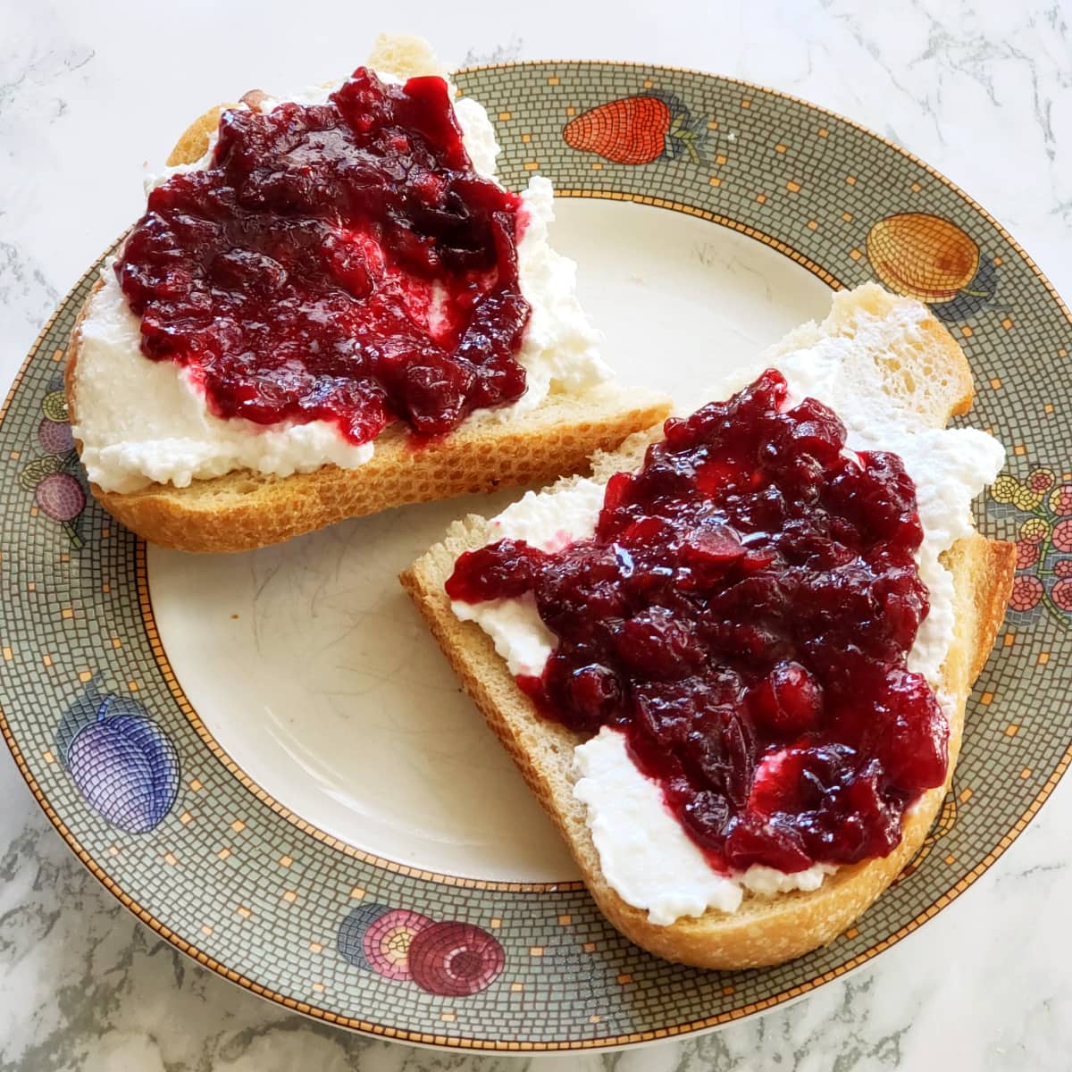 Baked Cranberry Sauce with Orange Liqueur on sourdough toast with cream cheese on top, for breakfast