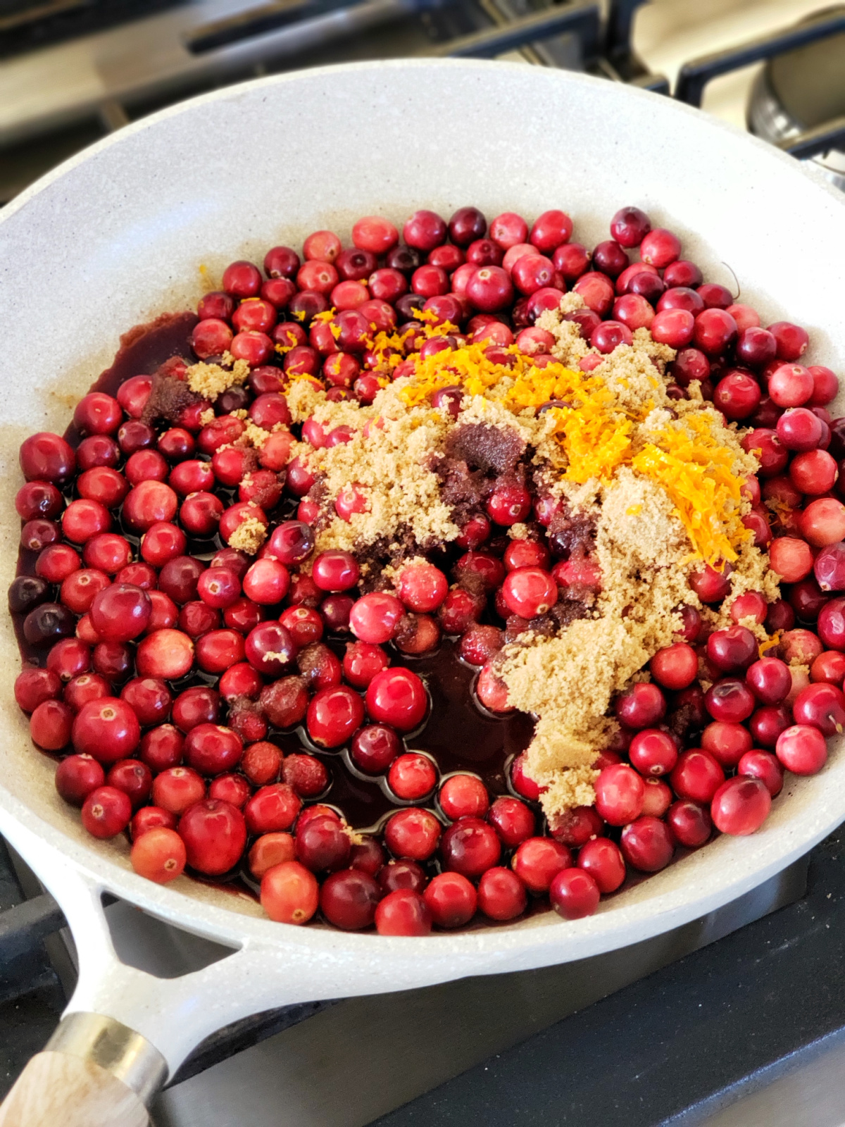 Ingredients for Skillet Cranberry Sauce with Port in a white skillet on a stovetop