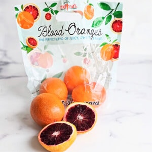 Bag of Blood oranges from Melissa's Produce on a white marble counter top