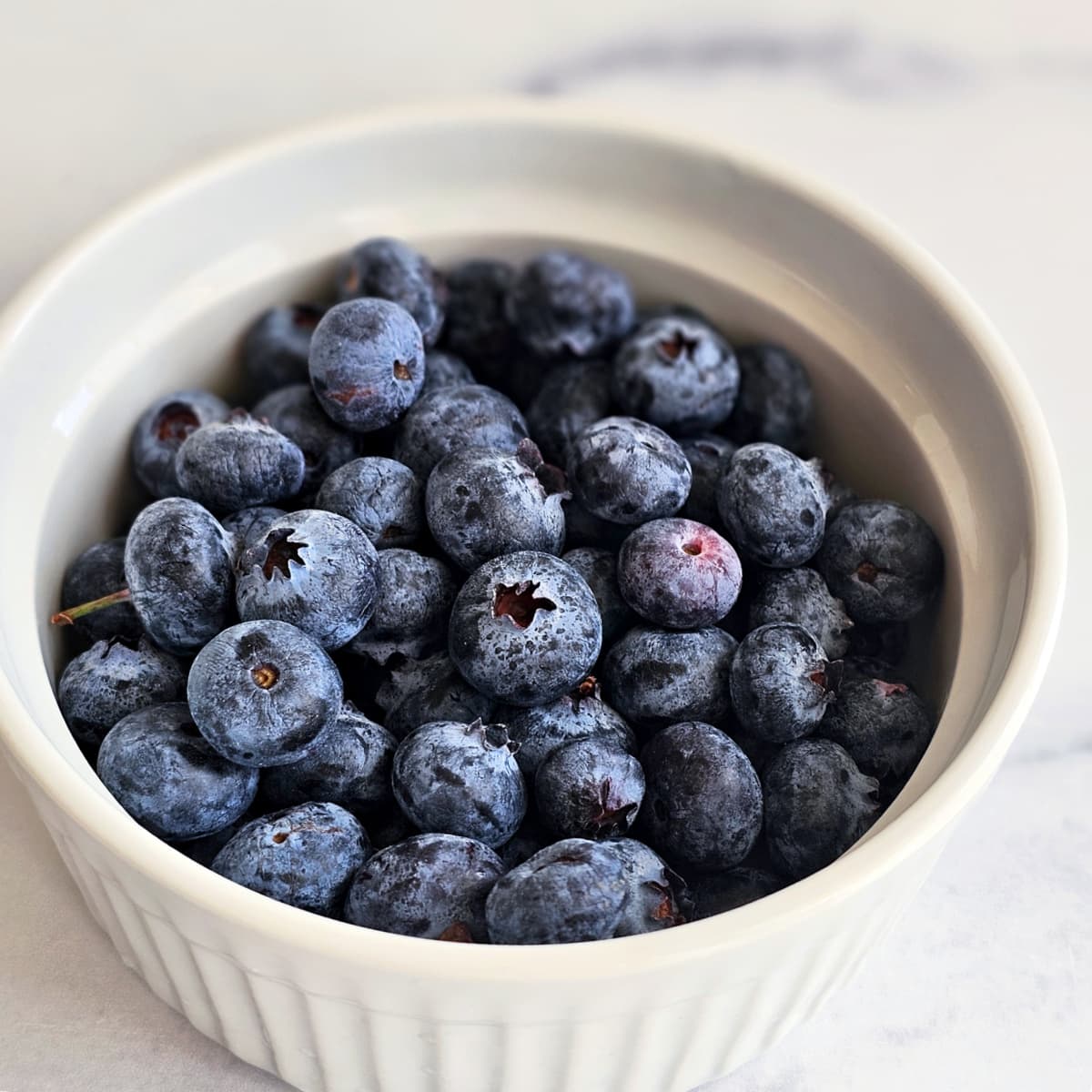 Blueberries in a white ramekin on ShockinglyDelicious.com