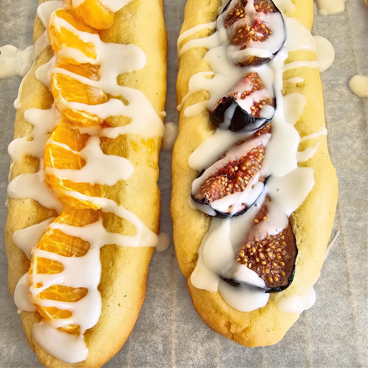 White glaze on top of 2 logs of Split Seconds Cookies -- one with tangerine segments and one with fig segments 