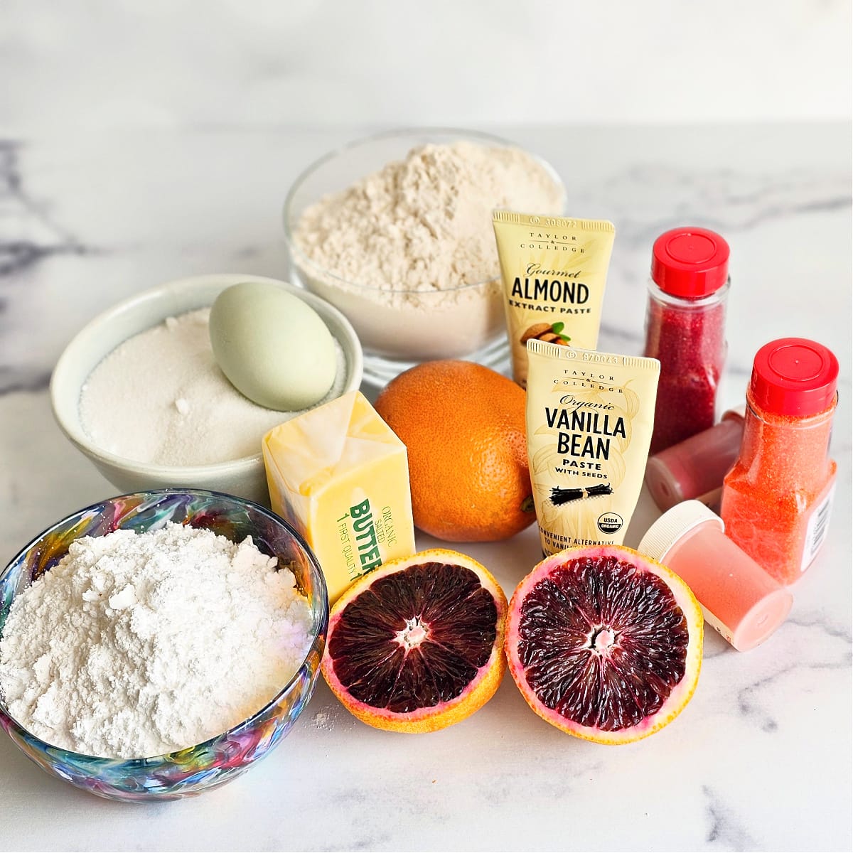 Ingredients for Blood Orange Crinkle Cookies on a white marble counter