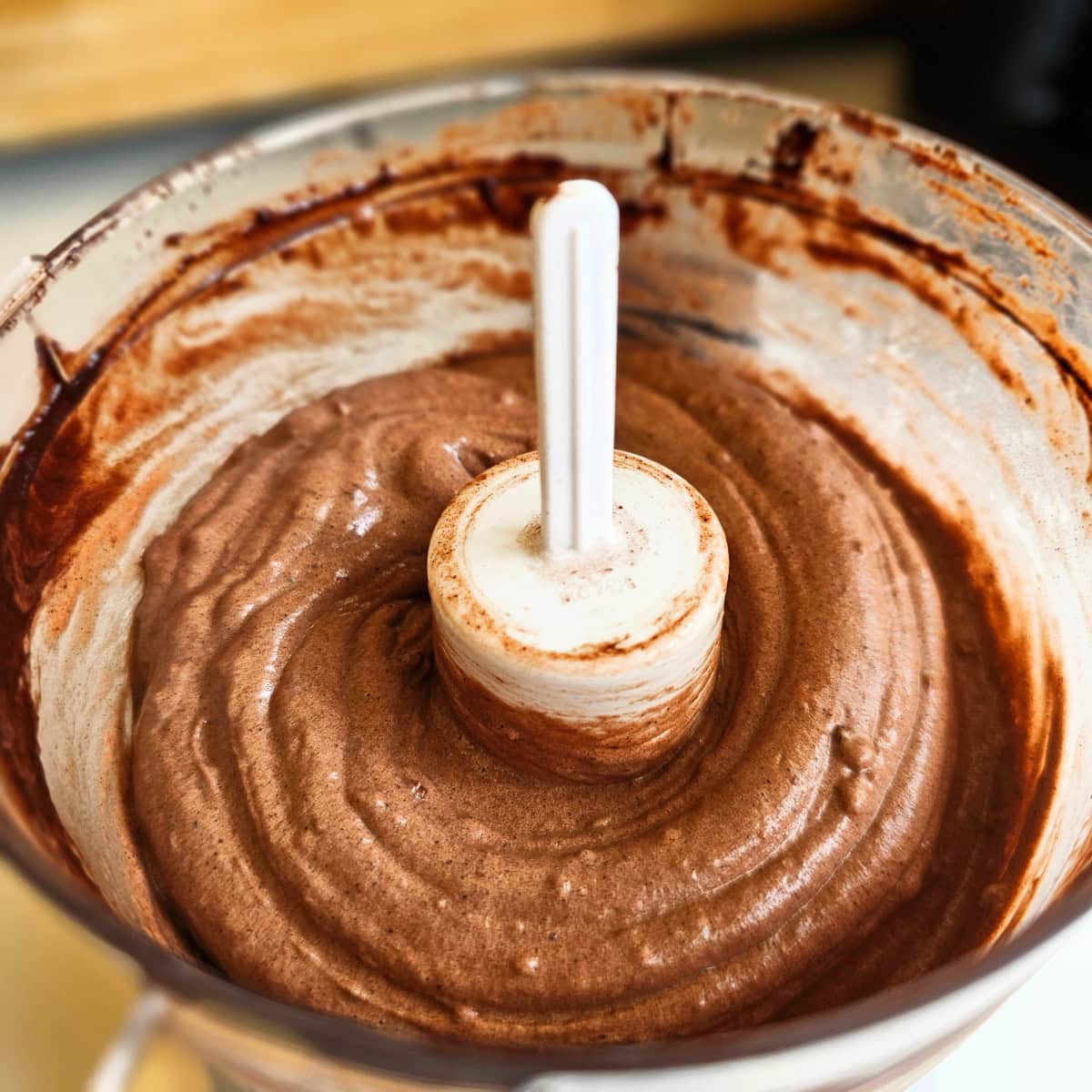 Vegan Chocolate Nice Cream whirled in a mini food processor with a white center post protruding from the center