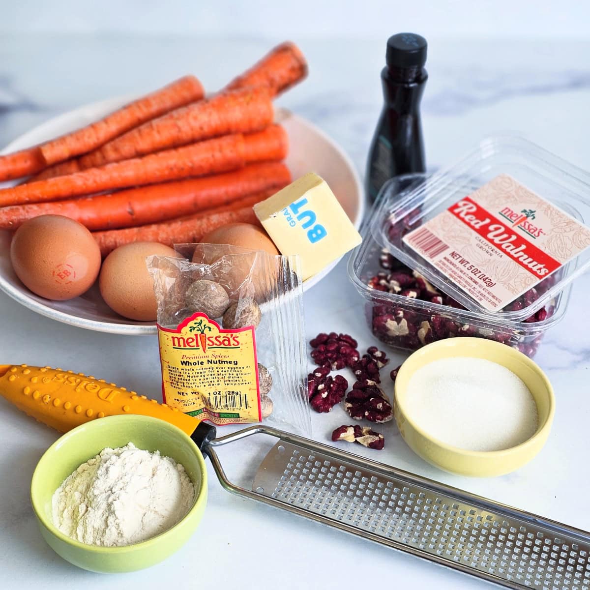 Ingredients for Carrot Souffle on a white marble countertop
