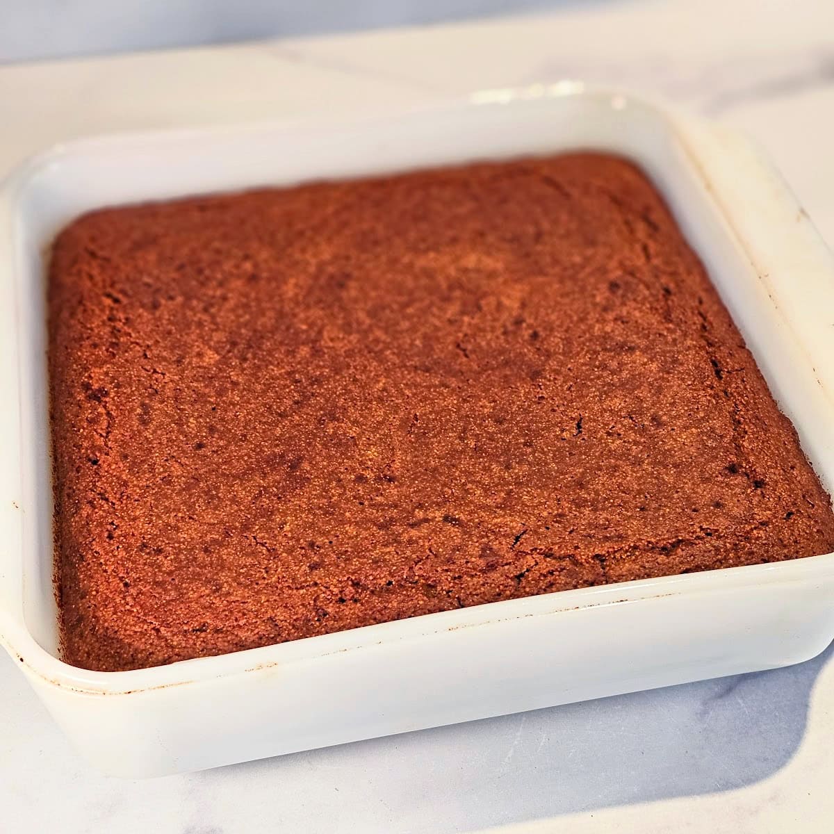 Molasses Cornbread in a white square baking dish on a white countertop
